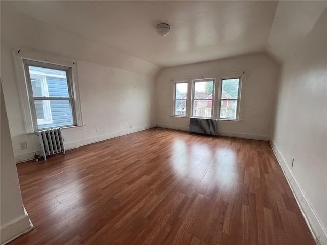 11617 141st St, Jamaica, NY 11436 - additional living space featuring radiator heating unit, vaulted ceiling, and wood finished floors
