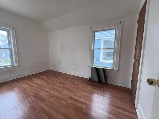 11617 141st St, Jamaica, NY 11436 - additional living space with radiator heating unit, lofted ceiling, and wood finished floors