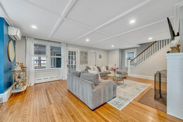 271 Foster Ave, Sayville, NY 11782 - living area with an AC wall unit, hardwood / wood-style flooring, a baseboard radiator, stairs, and plenty of natural light