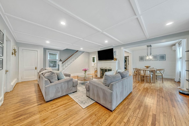 271 Foster Ave, Sayville, NY 11782 - living room featuring light wood-style flooring, stairs, a brick fireplace, recessed lighting, and a chandelier