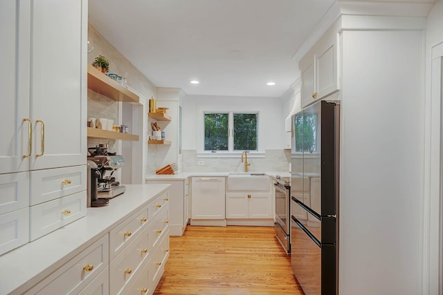 271 Foster Ave, Sayville, NY 11782 - kitchen with appliances with stainless steel finishes, white cabinetry, open shelves, light countertops, and light wood-type flooring
