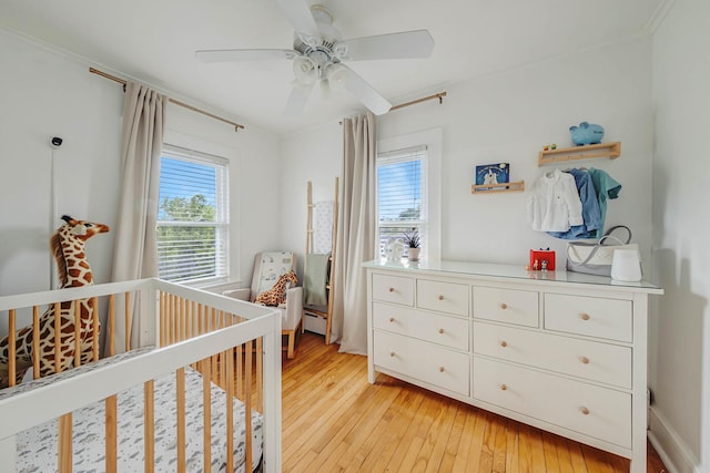 271 Foster Ave, Sayville, NY 11782 - bedroom featuring light wood-style floors, a nursery area, baseboard heating, a ceiling fan, and crown molding