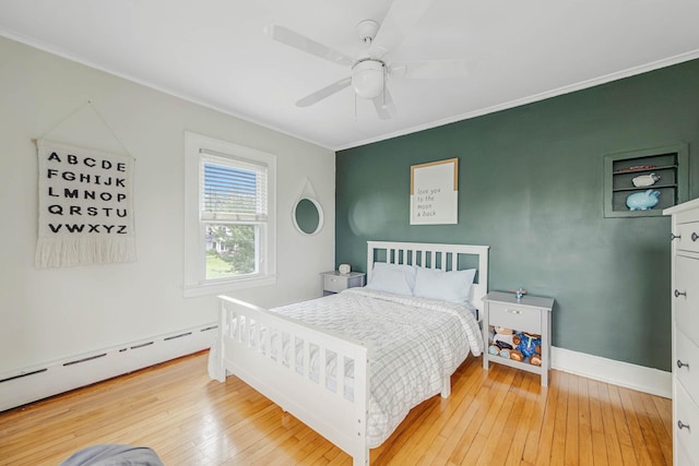 271 Foster Ave, Sayville, NY 11782 - bedroom featuring crown molding, a baseboard heating unit, hardwood / wood-style floors, and ceiling fan