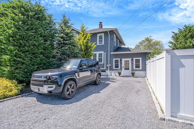 271 Foster Ave, Sayville, NY 11782 - rear view of house featuring a chimney and roof with shingles