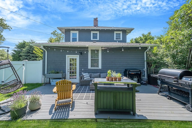 271 Foster Ave, Sayville, NY 11782 - rear view of house featuring a chimney, a wooden deck, outdoor lounge area, roof with shingles, and a gate