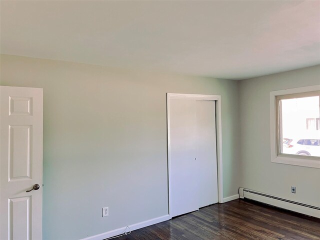 2453 Union Blvd Unit 3A, Islip, NY 11751 - unfurnished bedroom featuring baseboard heating, dark wood-type flooring, and a closet