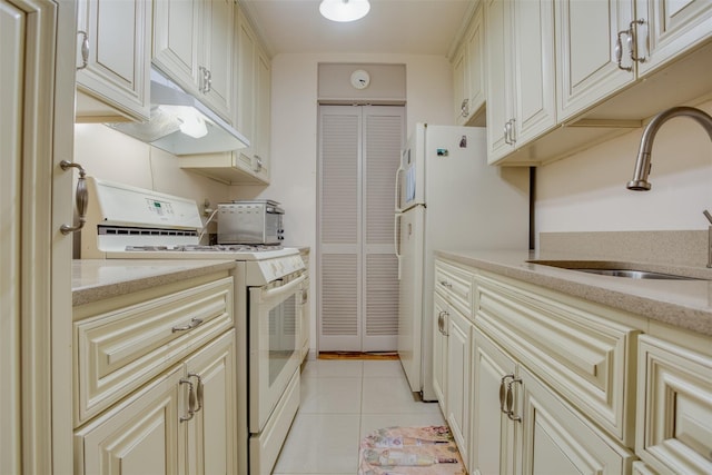 65-15 Alderton St Unit 2C, Rego Park, NY 11374 - kitchen featuring white appliances, under cabinet range hood, light tile patterned floors, cream cabinets, and light stone countertops