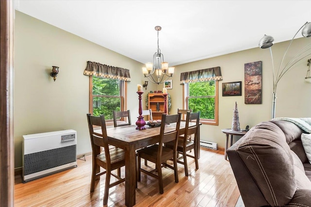 61 Travis Blvd, Catskill, NY 12414 - dining area featuring a chandelier, plenty of natural light, heating unit, and light wood finished floors