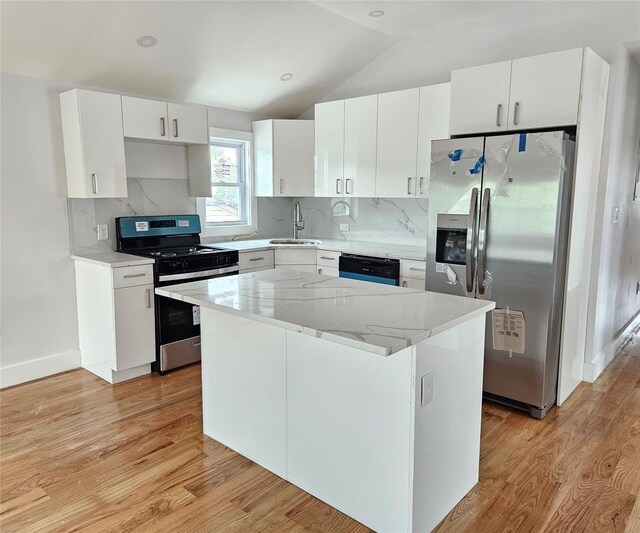 153-23 123rd Ave, Jamaica, NY 11434 - kitchen featuring stainless steel appliances, light wood finished floors, a center island, vaulted ceiling, and backsplash