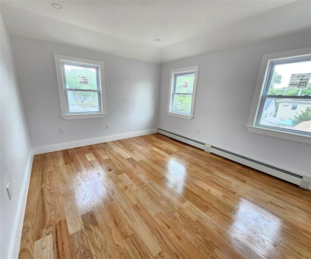 153-23 123rd Ave, Jamaica, NY 11434 - unfurnished room featuring a baseboard radiator and light wood-style floors