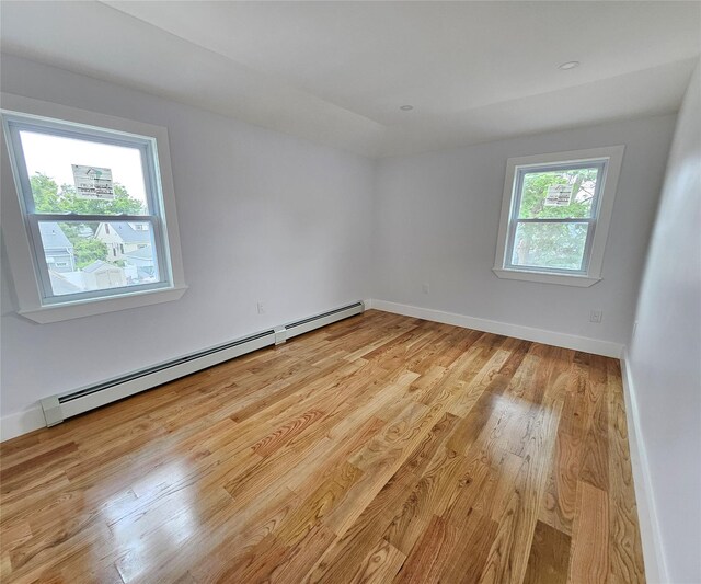 153-23 123rd Ave, Jamaica, NY 11434 - empty room with a baseboard radiator and light wood finished floors
