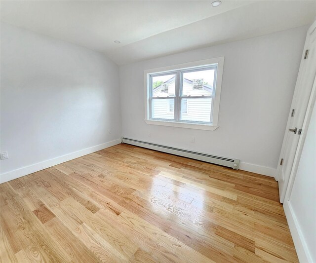 153-23 123rd Ave, Jamaica, NY 11434 - spare room featuring baseboard heating, lofted ceiling, and wood finished floors