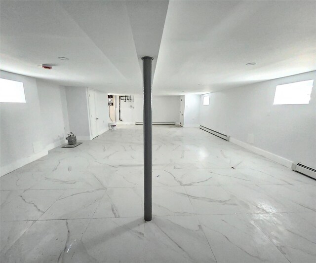 153-23 123rd Ave, Jamaica, NY 11434 - basement featuring baseboard heating, marble finish floors, and a baseboard heating unit