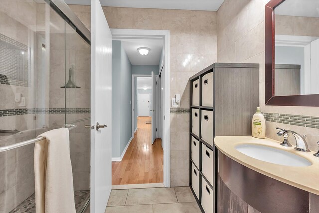 9 Foxwood Dr Unit 4, Pleasantville, NY 10570 - bathroom featuring tile walls, a shower stall, tile patterned floors, and vanity