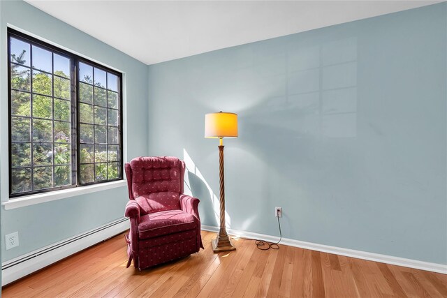 9 Foxwood Dr Unit 4, Pleasantville, NY 10570 - living area featuring a baseboard heating unit and wood finished floors