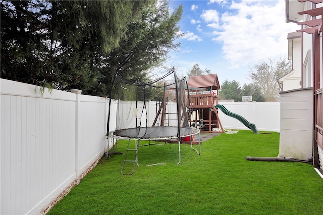 1013 S End Ave, Woodmere, NY 11598 - fenced backyard featuring a trampoline and a playground