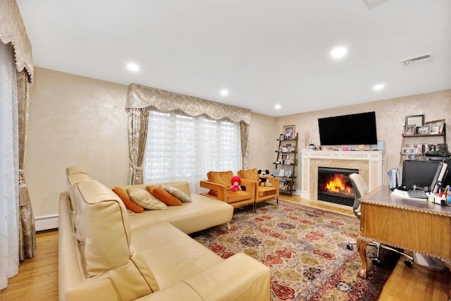 1013 S End Ave, Woodmere, NY 11598 - living area featuring a fireplace, wood finished floors, recessed lighting, and a baseboard radiator