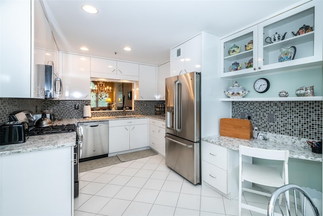 17 Jared Dr, White Plains, NY 10605 - kitchen with appliances with stainless steel finishes, decorative backsplash, white cabinets, a chandelier, and open shelves