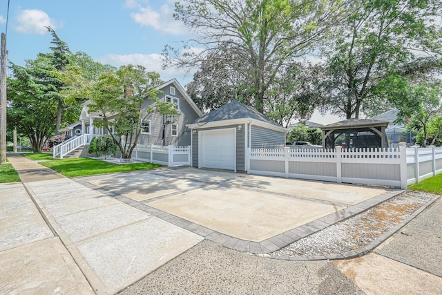 36 W Saint Marks Pl, Valley Stream, NY 11580 - view of front of home featuring concrete driveway, a garage, and an outdoor structure