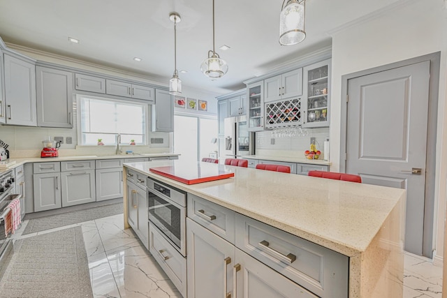 36 W Saint Marks Pl, Valley Stream, NY 11580 - kitchen featuring crown molding, stainless steel appliances, gray cabinets, light marble finish floors, and recessed lighting