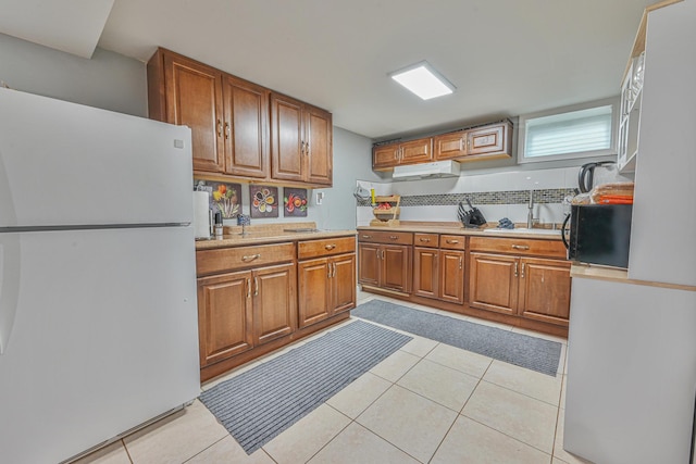 36 W Saint Marks Pl, Valley Stream, NY 11580 - kitchen featuring freestanding refrigerator, brown cabinetry, light countertops, and light tile patterned floors