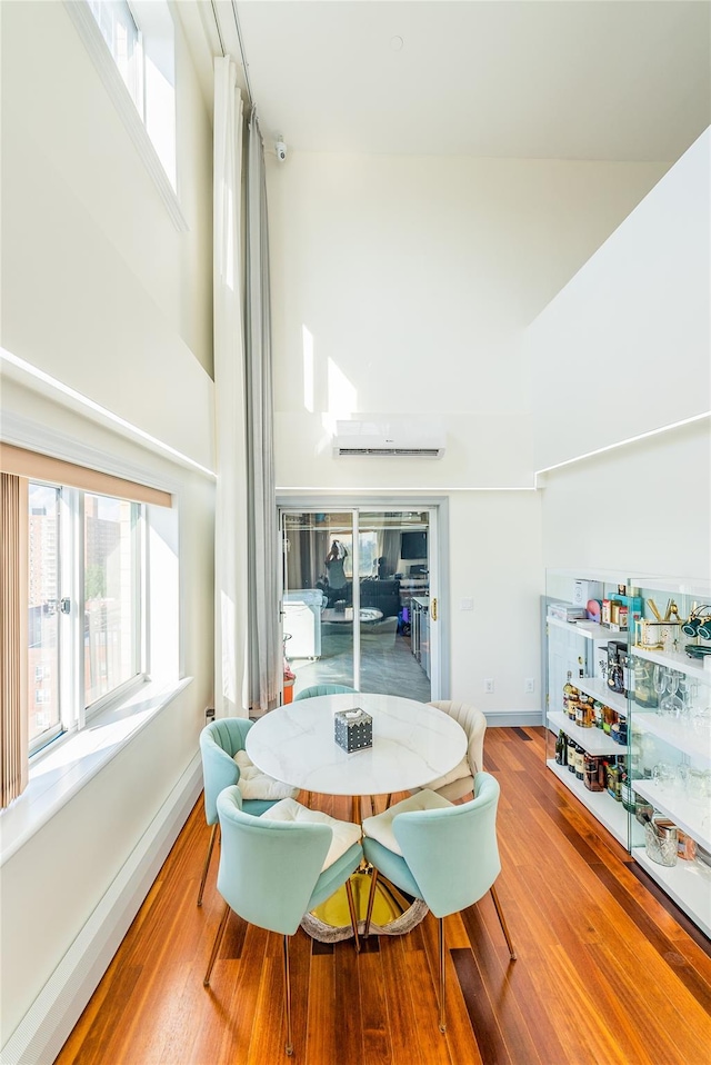 4318 Main St Unit 12A, Flushing, NY 11355 - dining space with a towering ceiling, plenty of natural light, and wood finished floors