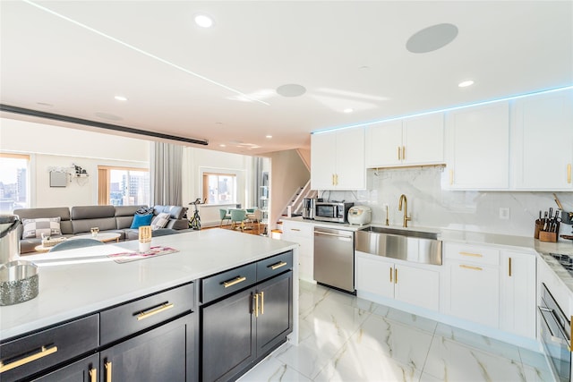 4318 Main St Unit 12A, Flushing, NY 11355 - kitchen featuring appliances with stainless steel finishes, white cabinetry, open floor plan, tasteful backsplash, and recessed lighting