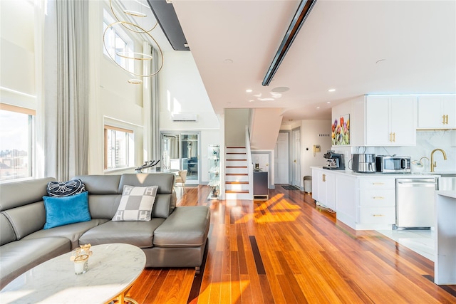 4318 Main St Unit 12A, Flushing, NY 11355 - living room featuring light wood finished floors, recessed lighting, and a towering ceiling