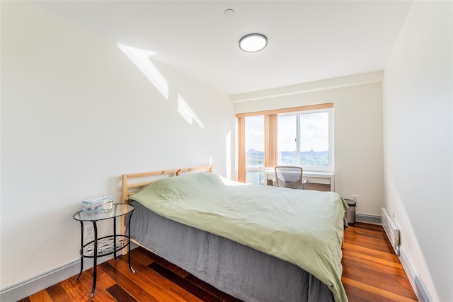 4318 Main St Unit 12A, Flushing, NY 11355 - bedroom featuring wood finished floors and baseboard heating