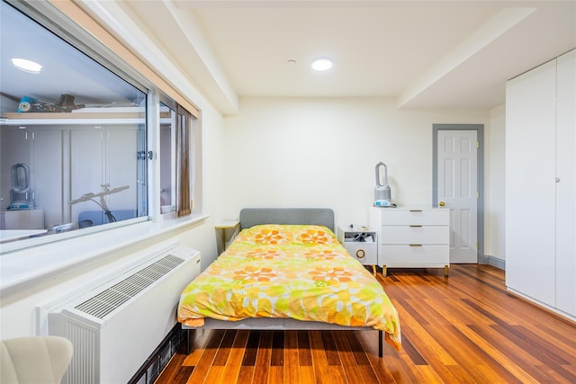 4318 Main St Unit 12A, Flushing, NY 11355 - bedroom with wood finished floors, radiator, and recessed lighting