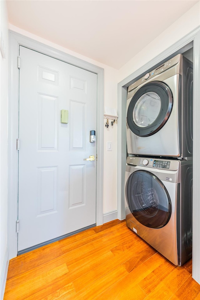 4318 Main St Unit 12A, Flushing, NY 11355 - washroom with stacked washer / dryer and light wood-style floors