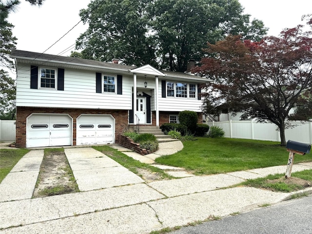 22 Kennedy Dr, Centereach, NY 11720 - raised ranch with concrete driveway, an attached garage, brick siding, and entry steps