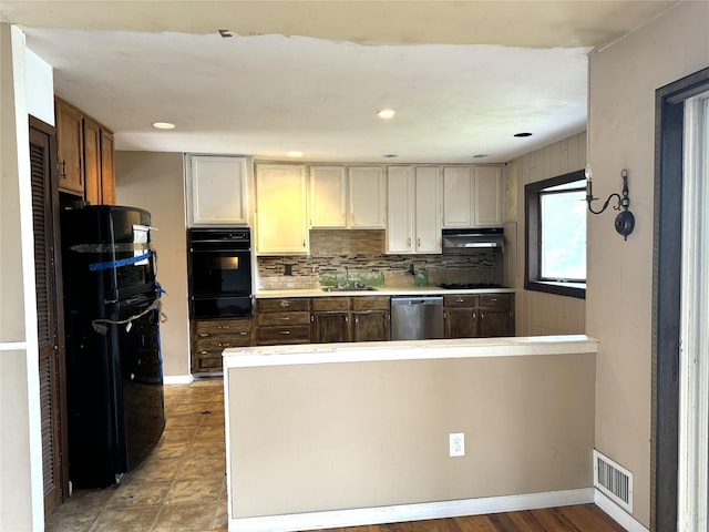22 Kennedy Dr, Centereach, NY 11720 - kitchen with black appliances, under cabinet range hood, a warming drawer, a peninsula, and light countertops