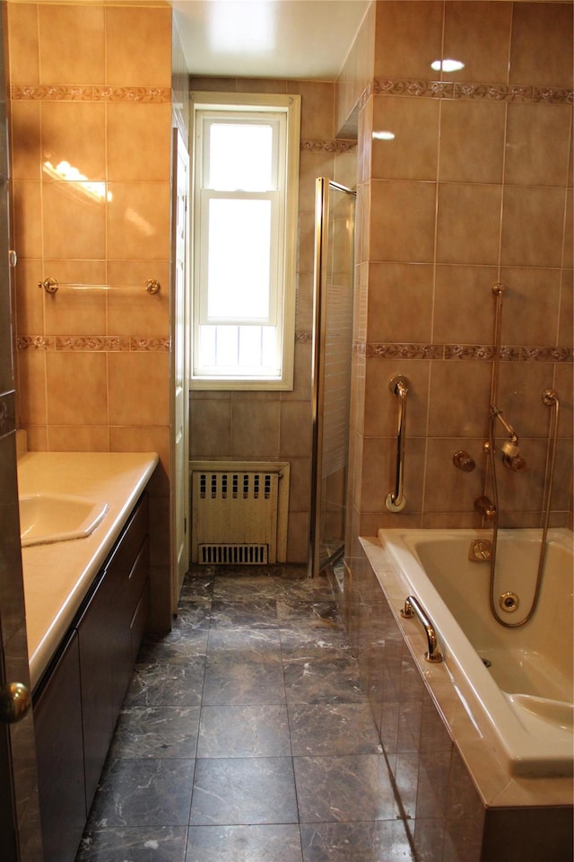 30-12 84th St, East Elmhurst, NY 11370 - bathroom featuring radiator heating unit, tile walls, and vanity