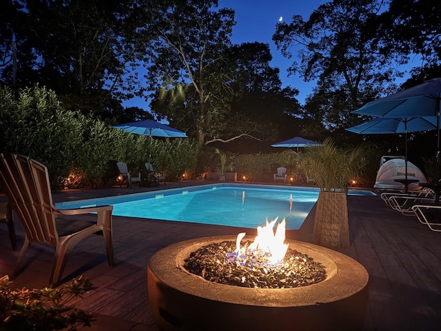 3 Yale, Hampton Bays, NY 11946 - pool at night with an outdoor fire pit