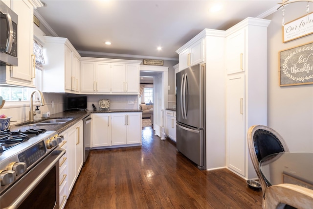 58 Hillside Ave, New Rochelle, NY 10801 - kitchen featuring appliances with stainless steel finishes, white cabinets, dark wood finished floors, ornamental molding, and recessed lighting