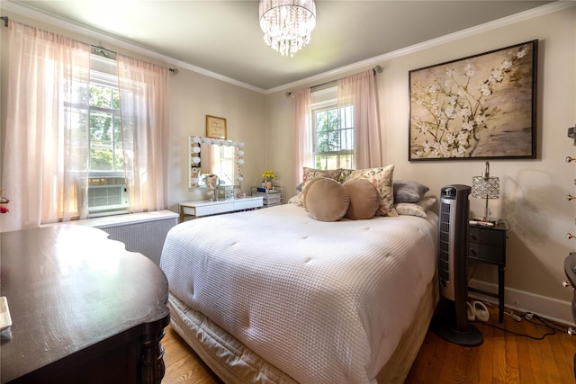 58 Hillside Ave, New Rochelle, NY 10801 - bedroom with wood finished floors, crown molding, cooling unit, and a chandelier