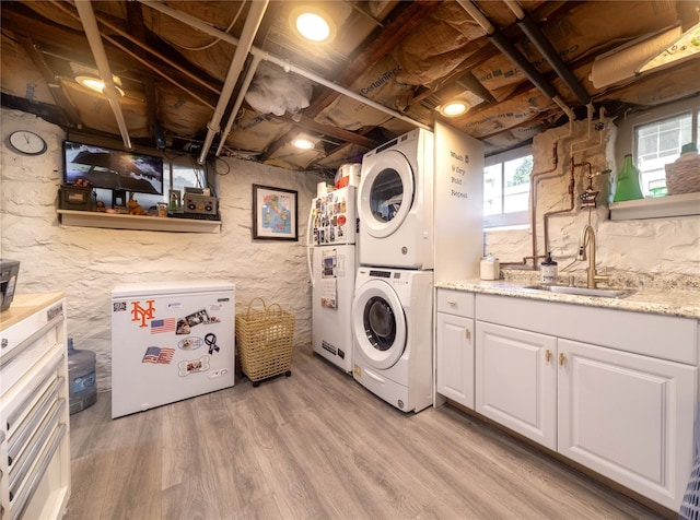 58 Hillside Ave, New Rochelle, NY 10801 - washroom with estacked washer and dryer and light wood-type flooring