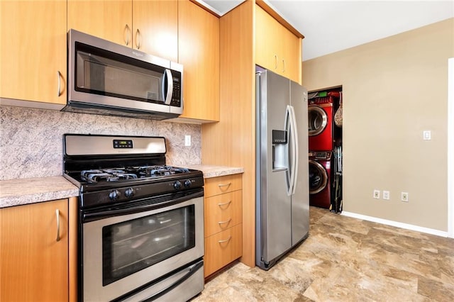135 28th Ave Unit 2A, Brooklyn, NY 11214 - kitchen featuring stainless steel appliances, stacked washing machine and dryer, tasteful backsplash, and light countertops