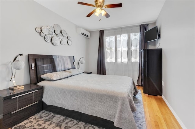 135 28th Ave Unit 2A, Brooklyn, NY 11214 - bedroom with a wall unit AC, wood finished floors, and ceiling fan