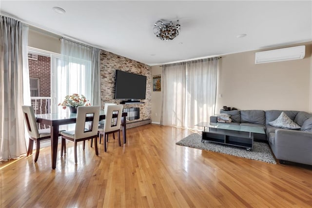 135 28th Ave Unit 2A, Brooklyn, NY 11214 - living area featuring a wall unit AC and light wood-style floors
