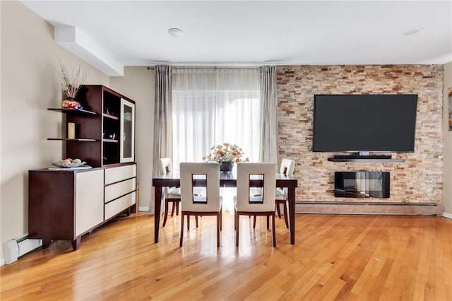 135 28th Ave Unit 2A, Brooklyn, NY 11214 - dining space featuring light wood-type flooring and a baseboard radiator