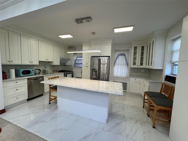 6360 102nd St Unit B19, Rego Park, NY 11374 - kitchen featuring stainless steel appliances, light marble finish flooring, a kitchen bar, and decorative backsplash