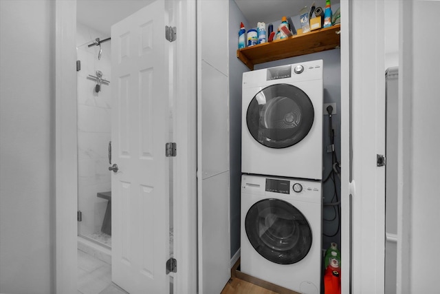 42 Richmond Blvd Unit 4B, Ronkonkoma, NY 11779 - laundry area featuring stacked washer / dryer and marble look tiles