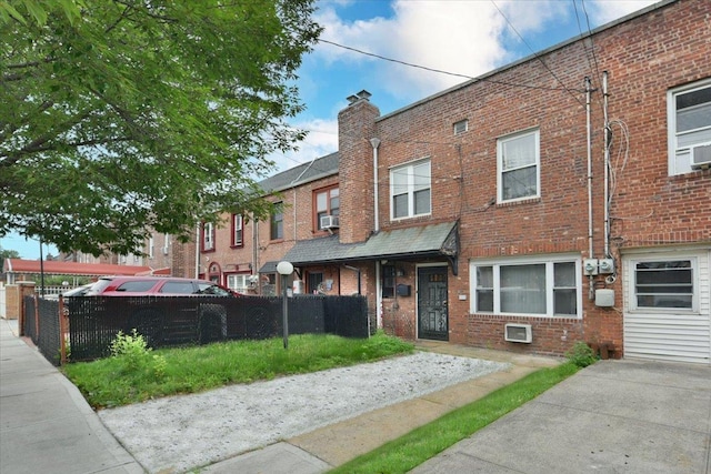 102-35 187th St, Hollis, NY 11423 - townhome / multi-family property featuring brick siding, a chimney, and cooling unit