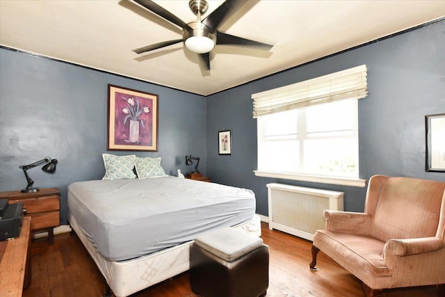 102-35 187th St, Hollis, NY 11423 - bedroom featuring radiator heating unit, wood finished floors, and a ceiling fan