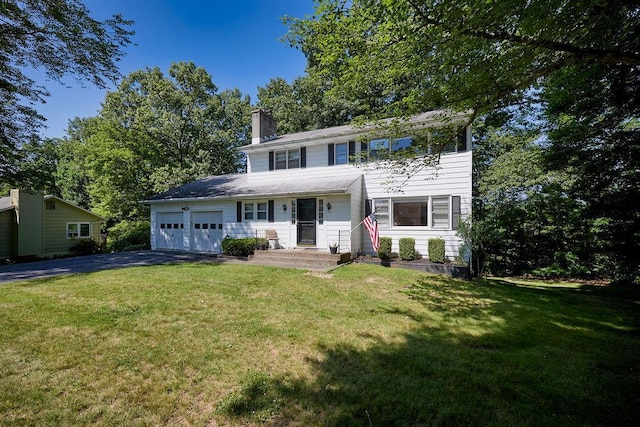 152 Bart Dr, Poughkeepsie, NY 12603 - view of front of property featuring driveway, a garage, a chimney, and a front lawn