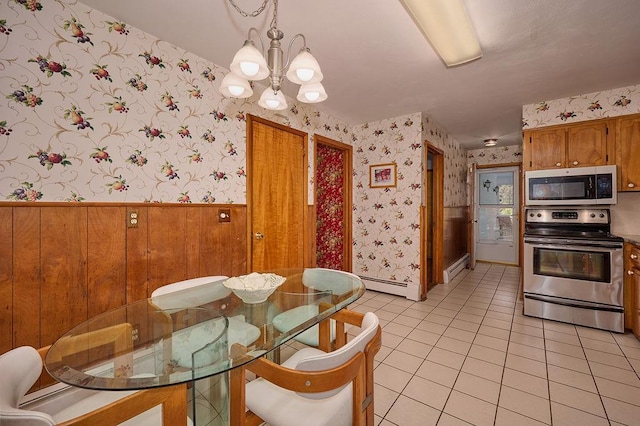 152 Bart Dr, Poughkeepsie, NY 12603 - dining space with wallpapered walls, a chandelier, a wainscoted wall, light tile patterned flooring, and a baseboard heating unit