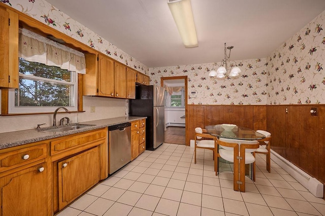 152 Bart Dr, Poughkeepsie, NY 12603 - kitchen with wallpapered walls, appliances with stainless steel finishes, a wainscoted wall, a chandelier, and a baseboard radiator