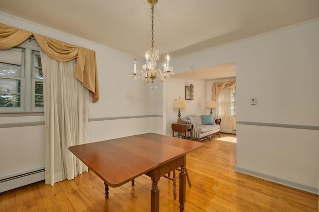 152 Bart Dr, Poughkeepsie, NY 12603 - dining area featuring a baseboard radiator, a chandelier, light wood-type flooring, and crown molding